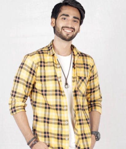 Pakistani Male Model posing in yellow shirt and blue jeans Pakistani Male Model posing in yellow shirt and blue jeans